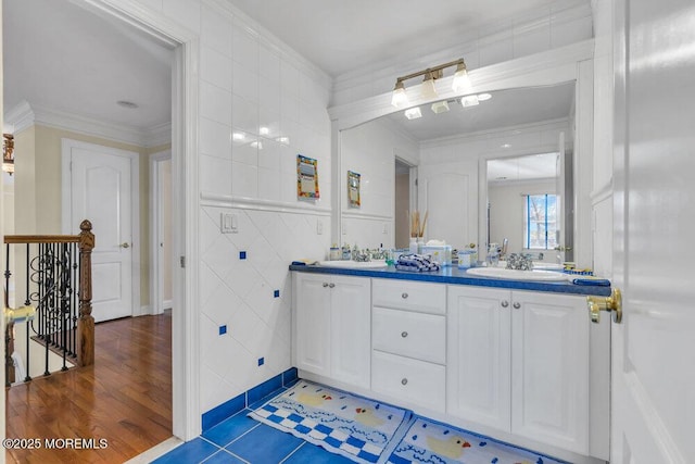 bathroom featuring hardwood / wood-style flooring, ornamental molding, tile walls, and vanity