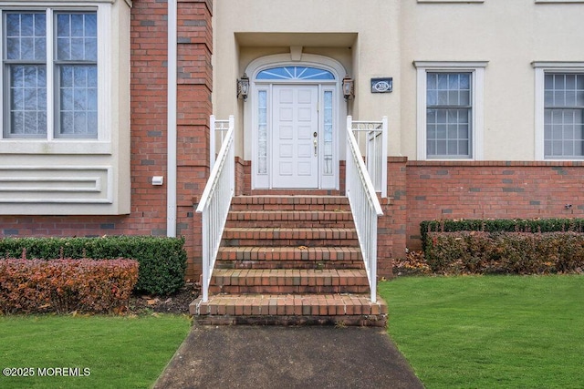 doorway to property with a yard