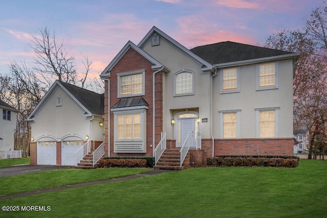 view of front property with a yard and a garage