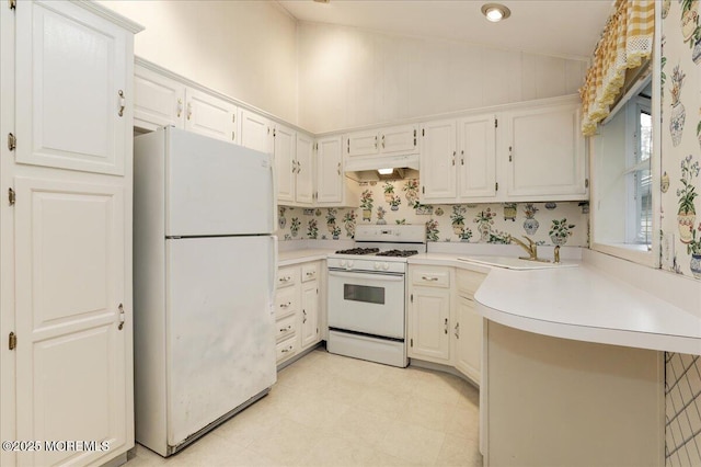 kitchen with white cabinetry, white appliances, sink, and vaulted ceiling