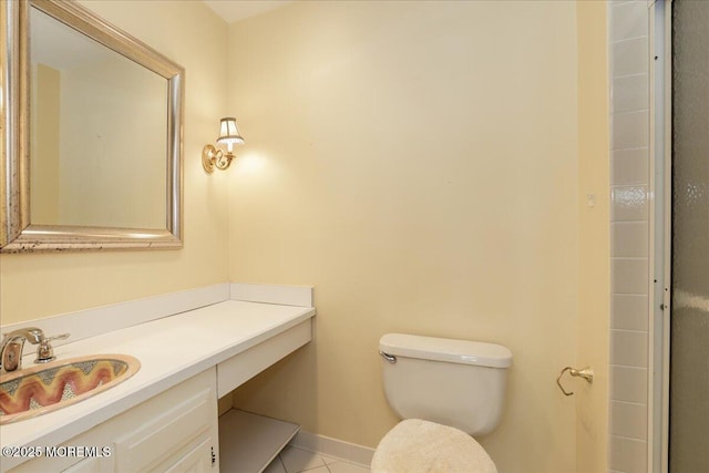 bathroom featuring vanity, tile patterned flooring, and toilet