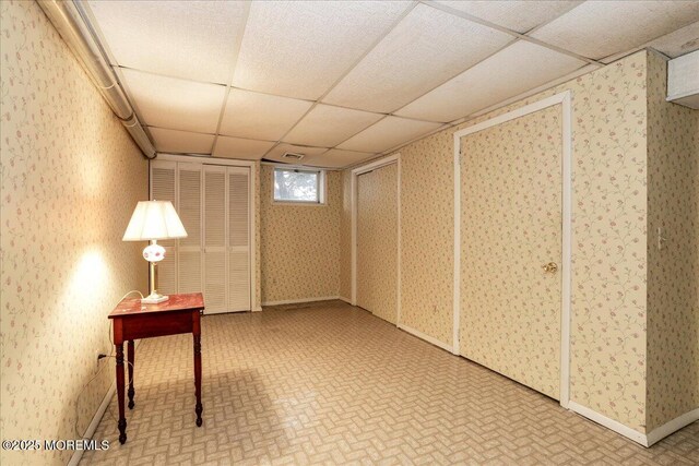 basement featuring a paneled ceiling