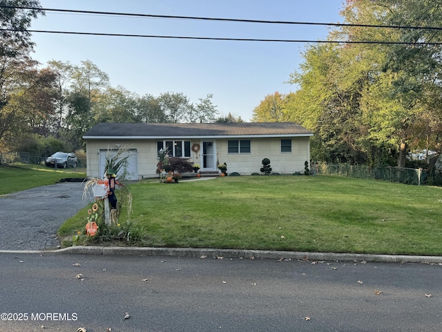 view of front of home featuring a garage and a front lawn