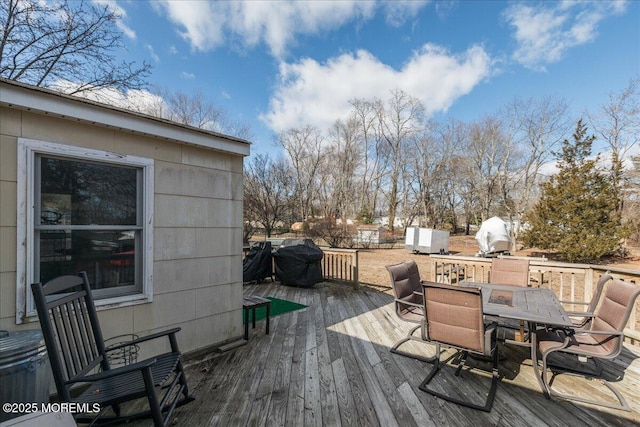 wooden deck featuring a grill