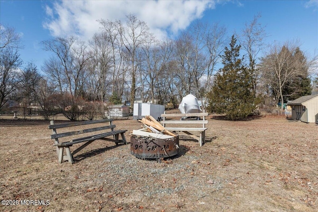 view of yard with an outdoor fire pit