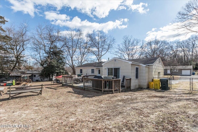 rear view of property with a wooden deck