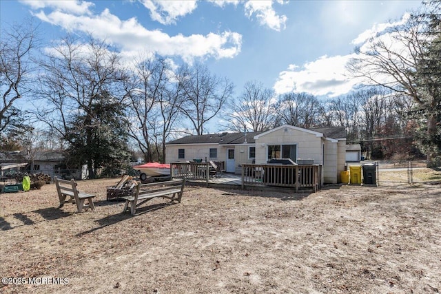 rear view of house with a wooden deck