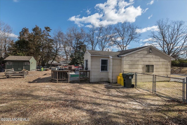 exterior space with a shed and a wooden deck