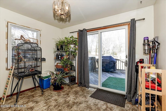 doorway with carpet floors and a chandelier