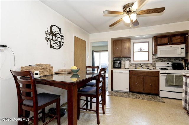 kitchen featuring tasteful backsplash, ceiling fan, sink, and white appliances