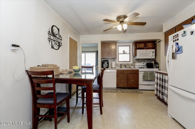 kitchen featuring ceiling fan, sink, backsplash, and white appliances