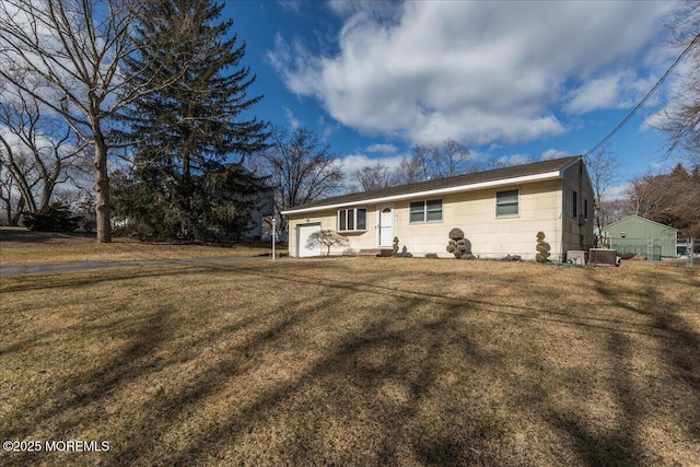 ranch-style home featuring cooling unit and a front yard