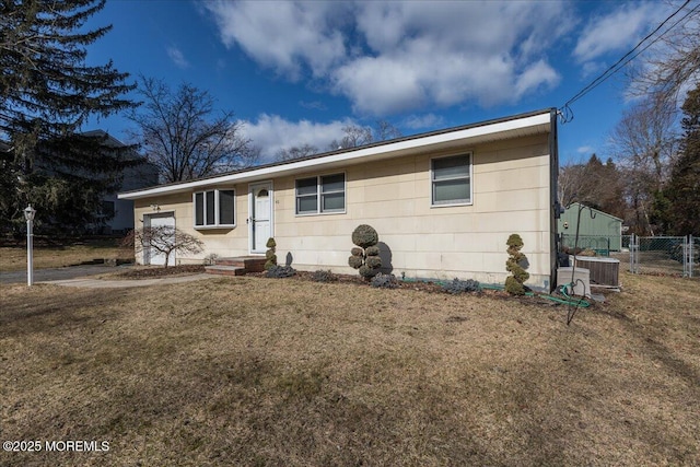 single story home featuring a front lawn and central air condition unit