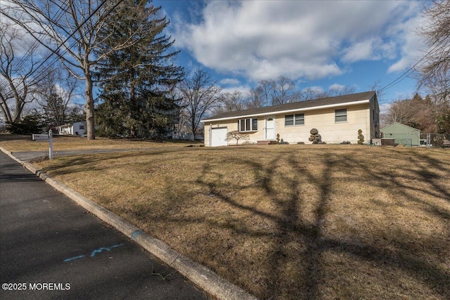 ranch-style home with a garage, central air condition unit, and a front lawn