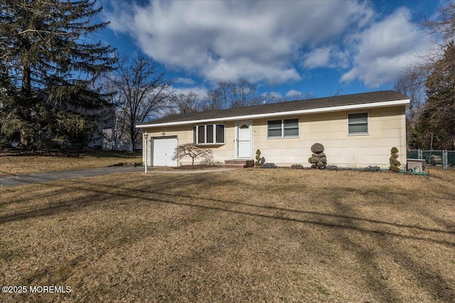 ranch-style home with a garage and a front lawn