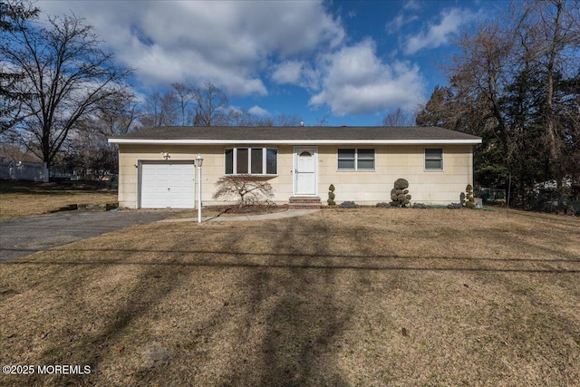 single story home with a garage and a front lawn