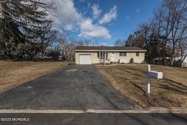 ranch-style house with a garage and a front lawn