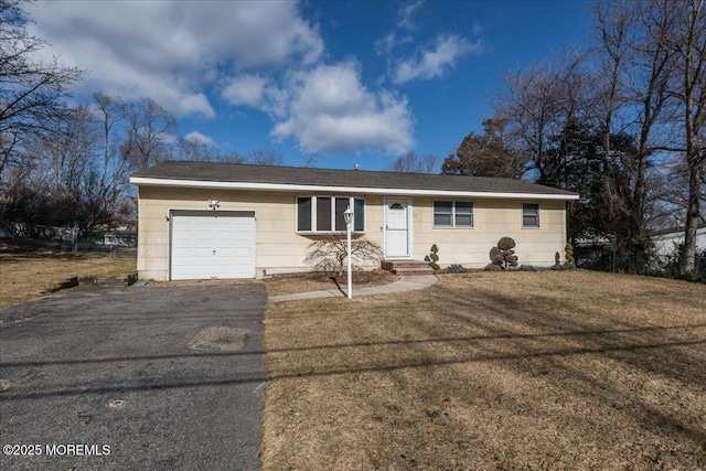 single story home featuring a garage and a front lawn