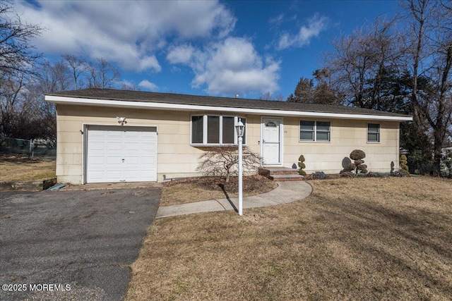 ranch-style home featuring a garage and a front lawn