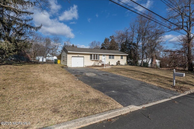 view of front of property featuring a garage and a front lawn