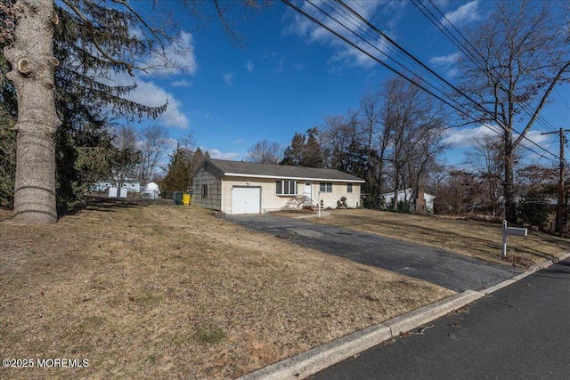 view of front of property with a garage and a front yard