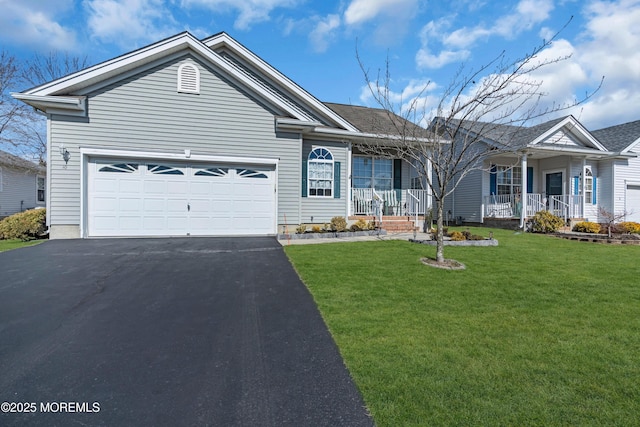 ranch-style home featuring a front yard, covered porch, driveway, and an attached garage