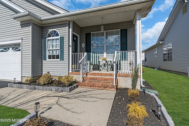 doorway to property with a garage, a porch, and a lawn