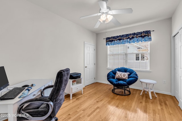 home office featuring ceiling fan, light wood-style flooring, and baseboards