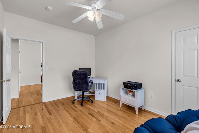 office space with a ceiling fan, light wood-style flooring, and baseboards