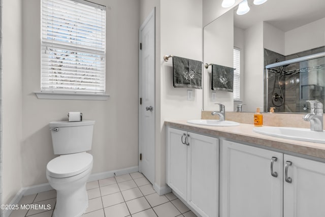 full bath featuring toilet, tile patterned flooring, a shower stall, and a sink