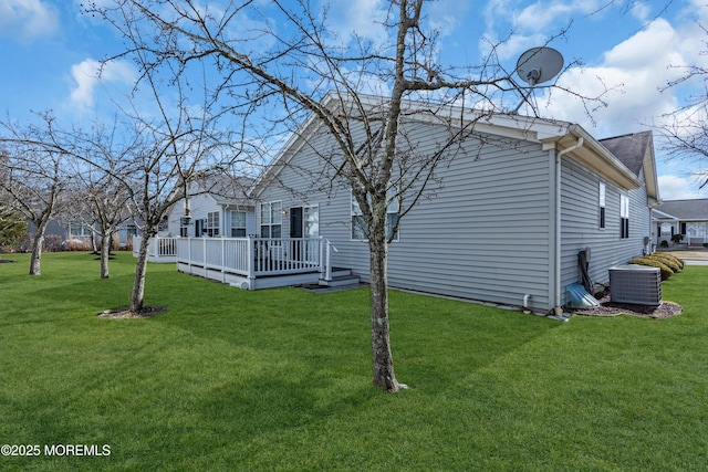 view of side of home featuring central AC unit, a lawn, and a wooden deck