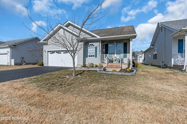 single story home with an attached garage, covered porch, a front lawn, and aphalt driveway