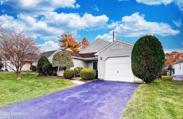 view of front of home with a garage and a front lawn