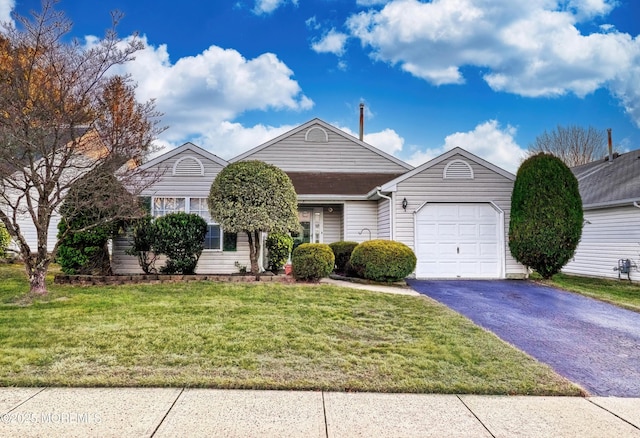 view of front of house featuring a garage and a front lawn