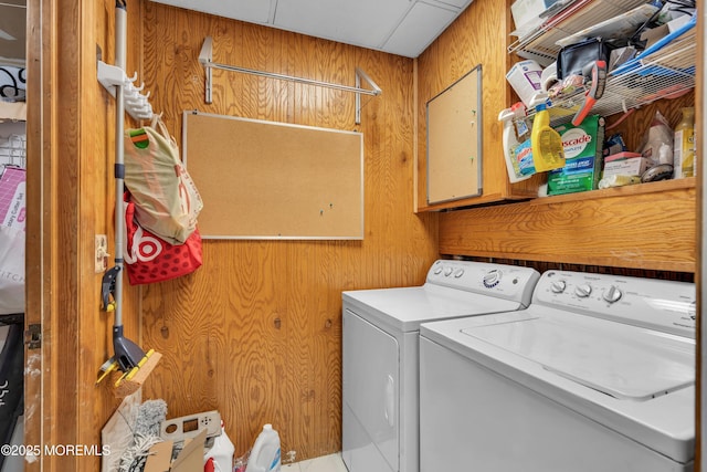 laundry area with washer and clothes dryer and wood walls