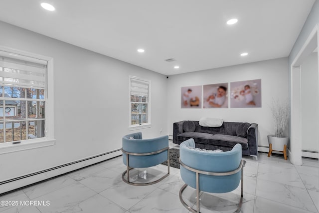 living room featuring a baseboard radiator and a wealth of natural light