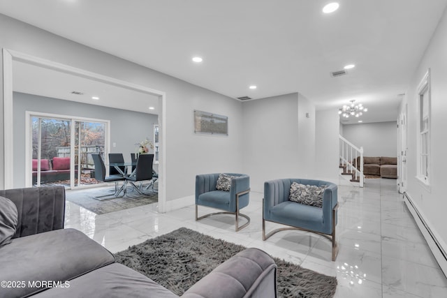 living room with a baseboard radiator and a chandelier