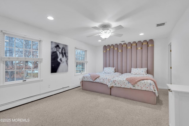 bedroom with carpet floors, a baseboard heating unit, and ceiling fan