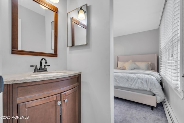 bathroom featuring baseboard heating and vanity