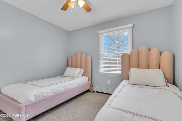 bedroom with a baseboard radiator, light colored carpet, and ceiling fan