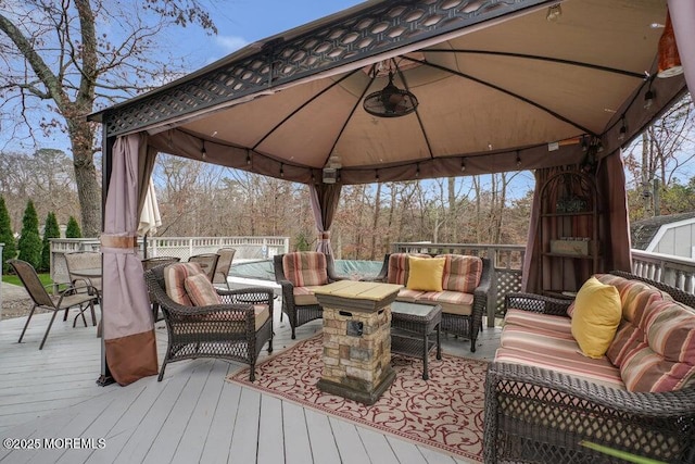 deck with an outdoor living space and a gazebo