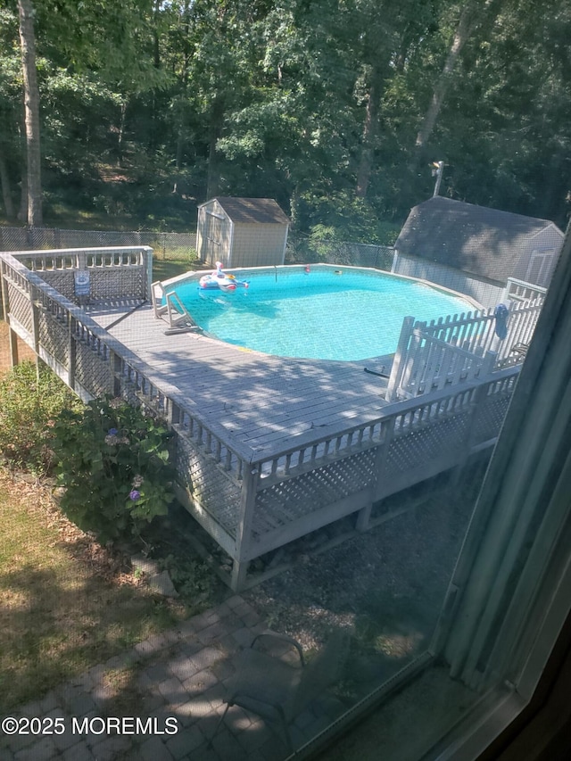 view of pool with a shed