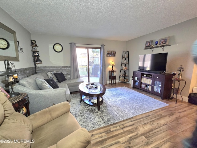 living room featuring hardwood / wood-style floors and a textured ceiling