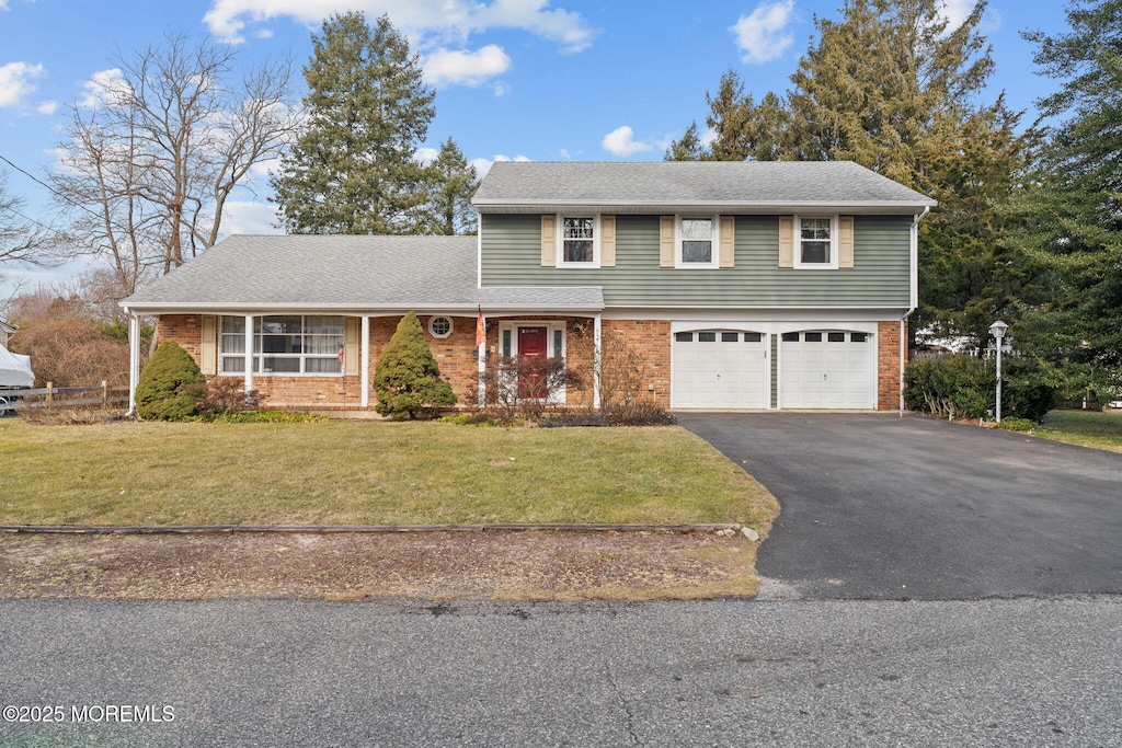 front facade with a garage and a front yard