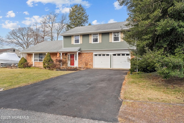 view of property featuring a garage and a front yard