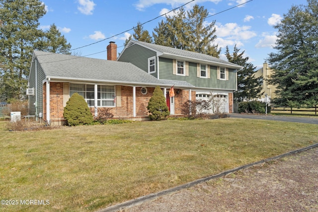 front of property with a garage and a front lawn