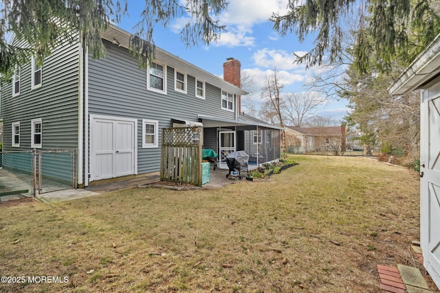 back of property featuring a lawn