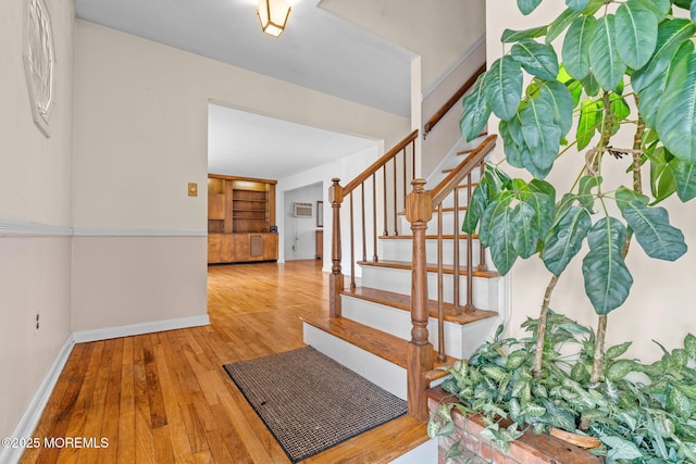 staircase with wood-type flooring