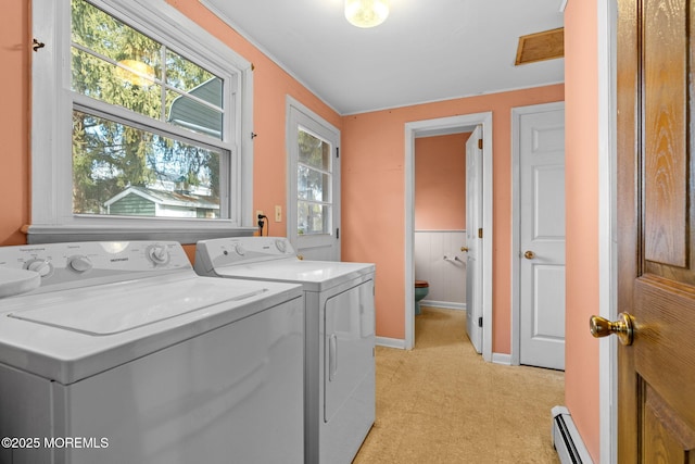 clothes washing area with washer and clothes dryer and baseboard heating