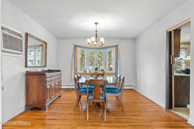 dining area with an inviting chandelier, a baseboard radiator, a wall mounted air conditioner, and light hardwood / wood-style floors